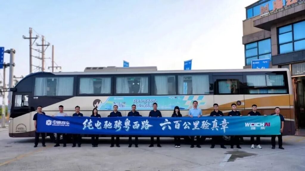 Zhongtong coach and participants holding a route-test banner